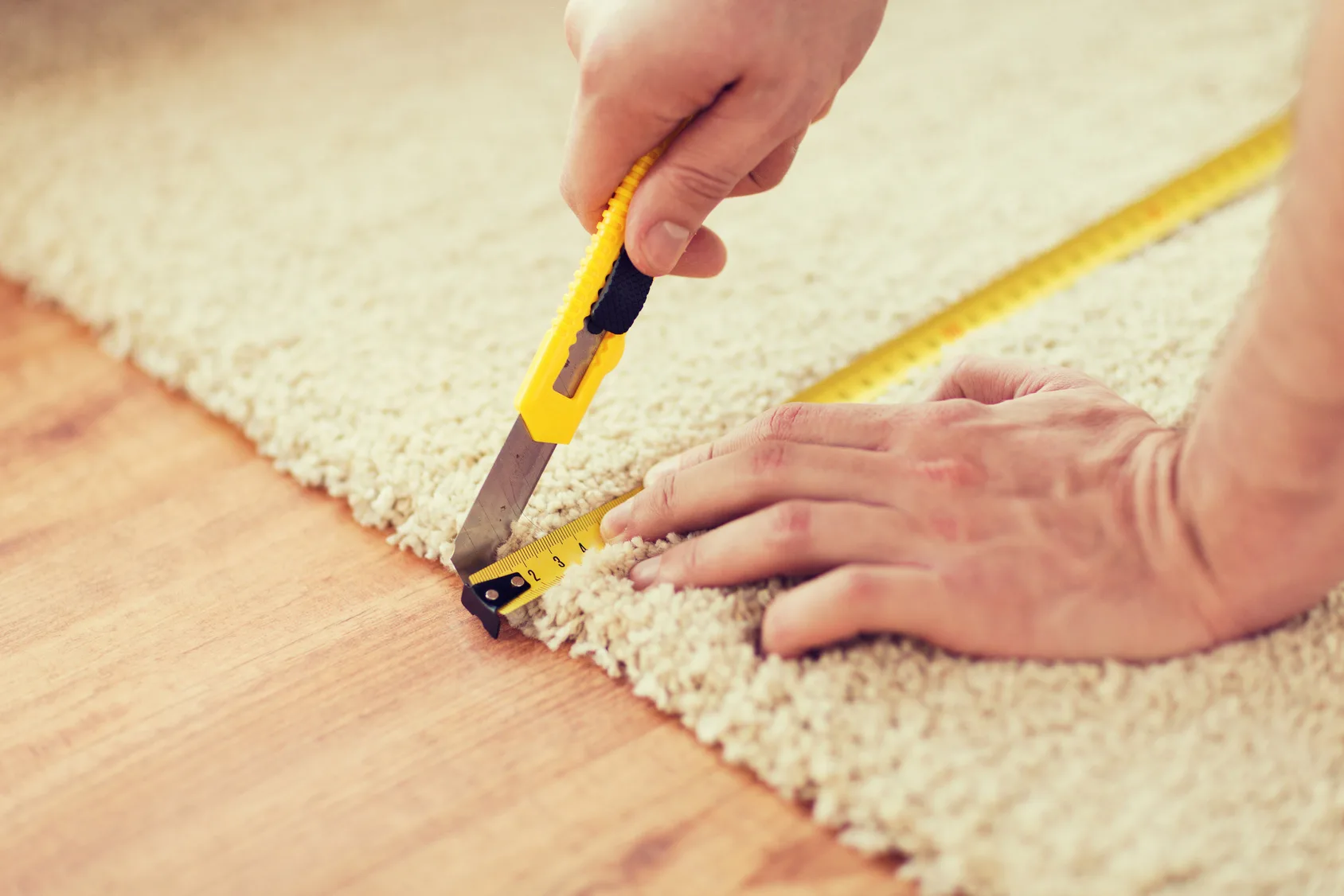 Contractor cutting a carpet in Indianapolis, IN